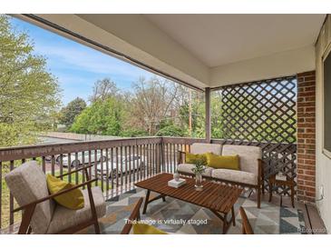 Cozy staged patio with comfortable seating and a view of the outdoors at 3663 S Sheridan Blvd # J12, Denver, CO 80235