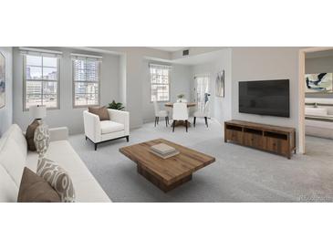 Bright living room features large windows, wood floors, and neutral decor at 300 W 11Th Ave # 5I, Denver, CO 80204