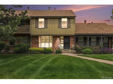 Charming townhome with a well-manicured lawn and inviting brick facade at 9031 E Amherst Dr # D, Denver, CO 80231