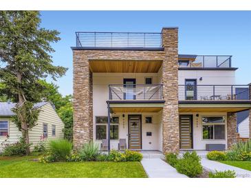 Modern townhouse showcasing a stone facade, balconies, and a rooftop deck at 4455 Tejon St, Denver, CO 80211