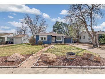 Charming blue home featuring well-kept landscaping, stone and a walkway to the front door at 2718 S Hazel Ct, Denver, CO 80236
