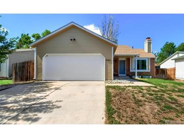 Charming single-Gathering home featuring an attached garage and a well-maintained front lawn at 8483 Sandreed Cir, Parker, CO 80134