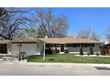 Charming ranch-style home with a well-manicured lawn and inviting curb appeal on a sunny day at 3281 Vivian Dr, Wheat Ridge, CO 80033