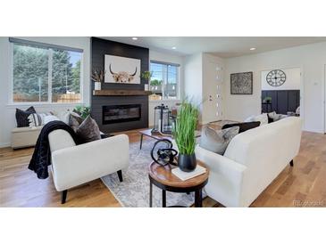 Bright living room features a fireplace and hardwood floors at 5601 E Iowa Ave, Denver, CO 80224