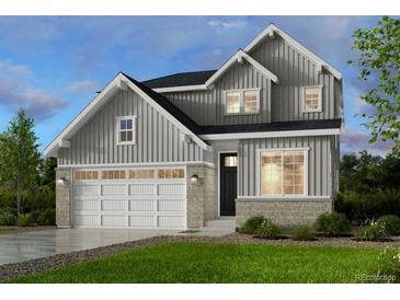 Charming two-story home with vertical siding, stone accents and a spacious two car garage at 17719 Prairie Peak Trl, Parker, CO 80134