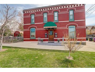 Charming two-story brick building with a well-maintained lawn and inviting entrance at 124 E Colorado Ave # 2, Denver, CO 80210