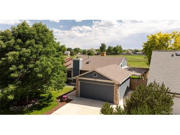 Well-maintained home featuring a two-car garage, mature trees and landscaped yard at 11381 Jay St, Westminster, CO 80020