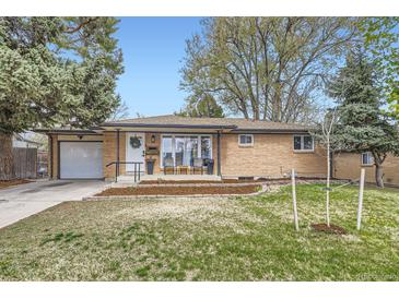 Charming brick home with a well-manicured front yard, attached garage, and a welcoming entrance at 7080 Beach St, Westminster, CO 80030