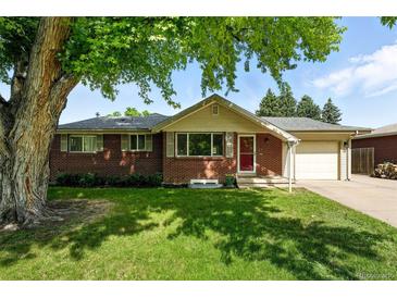 Charming brick home with a well-manicured lawn and mature tree in a suburban neighborhood at 470 S Queen St, Lakewood, CO 80226
