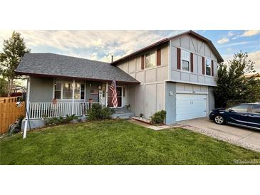 Charming two-story home with well-manicured lawn, inviting porch, and attached garage at 5255 S Waco St, Centennial, CO 80015
