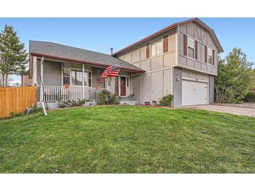 Charming two-story home with well-manicured lawn and beautiful landscaping at 5255 S Waco St, Centennial, CO 80015
