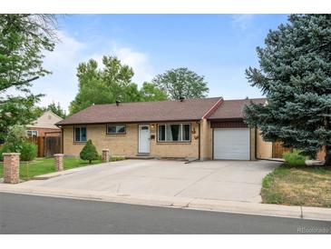 Charming single-story home features a well-maintained lawn and a large driveway at 1470 S Yates St, Denver, CO 80219