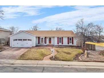 Charming single-Gathering home with a well-manicured lawn and a cozy front porch at 16308 E Wyoming Dr, Aurora, CO 80017