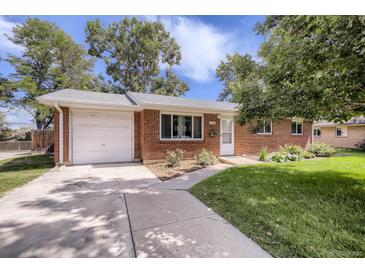 Charming red brick home featuring a one-car garage and a well-manicured lawn under a sunny, partly cloudy sky at 3205 Moorhead Ave, Boulder, CO 80305