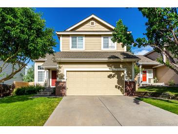 Charming two-story home with attached garage and inviting curb appeal on a sunny day at 5972 S Zante Way, Aurora, CO 80015