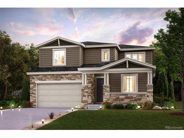 Beautiful two-story home with stone accents, manicured lawn and a two car garage at 14115 Bunny Hop Ln, Parker, CO 80134