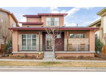 Charming home featuring a cozy front porch with rocking chairs and attractive architectural details at 89 Oneida St, Denver, CO 80230
