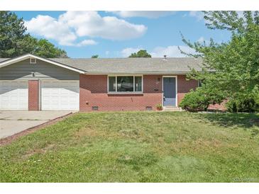 Charming single-story brick home with a well-maintained lawn and attached two-car garage at 4715 Garland St, Wheat Ridge, CO 80033