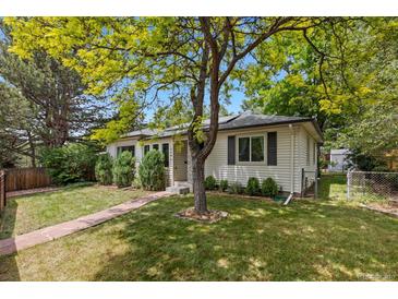 Charming home featuring a well-maintained lawn, mature trees, and a welcoming walkway leading to the front entrance at 3209 E Yale Way, Denver, CO 80210