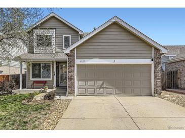Charming home with a two-car garage and inviting brick-accented entrance at 4222 S Himalaya Way, Aurora, CO 80013