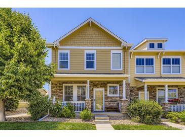 Charming two-story home featuring stone accents, a welcoming porch, and manicured landscaping at 13626 Garfield St # A, Thornton, CO 80602