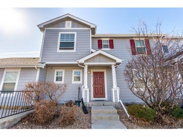Charming home featuring a covered entrance and red shutters that add character and curb appeal at 5830 Ceylon St # B, Denver, CO 80249