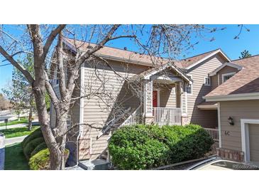 Charming townhouse featuring a cozy front porch and well-maintained landscaping at 7700 W Grant Ranch Blvd # 4A, Littleton, CO 80123