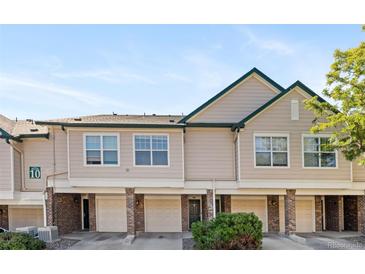 Exterior view of townhomes featuring brick accents and individual garages for each unit at 2154 Concord Ln, Superior, CO 80027