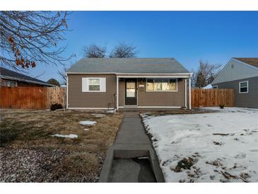 Cute bungalow home with a well-maintained lawn and walkway at 1190 Elmira St, Aurora, CO 80010