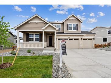 Charming two-story home with landscaped yard, a welcoming porch, and a three-car garage at 7036 E 126Th Pl, Thornton, CO 80602