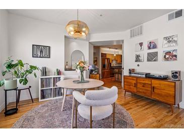 Inviting dining area features stylish decor and seamlessly connects to the adjacent kitchen at 2195 Decatur St # 212, Denver, CO 80211