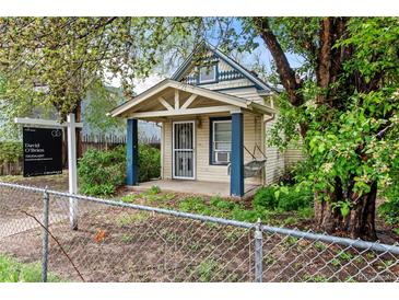 Charming home with a covered porch, blue trim, and a well-maintained front yard at 4151 Zenobia St, Denver, CO 80212