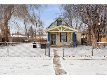 Charming bungalow-style home with mature trees and a snow-covered front yard behind a chain-link fence at 4151 Zenobia St, Denver, CO 80212