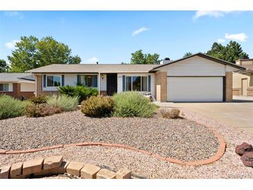 Charming ranch-style home with tidy front yard and attached two-car garage at 17601 E Eastman Pl, Aurora, CO 80013