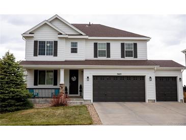 Beautiful two-story home featuring a three car garage and covered porch at 7603 Sabino Ln, Castle Rock, CO 80108