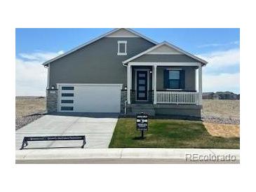 Charming single-Gathering home with a well-manicured lawn, covered entry, and an attached two-car garage at 42982 Colonial Trl, Elizabeth, CO 80107
