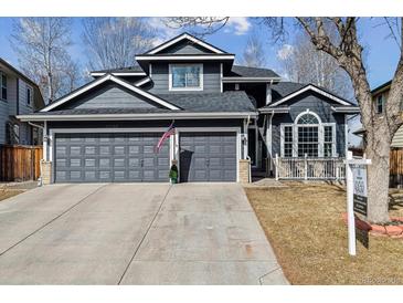 Charming two-story home boasts a three-car garage and well-manicured front yard at 10535 Cottoneaster Way, Parker, CO 80134