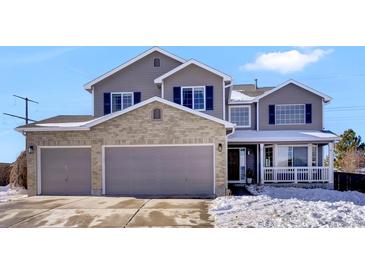 Two-story house with gray siding, three-car garage, and snowy front yard at 1607 Rosedale St, Castle Rock, CO 80104