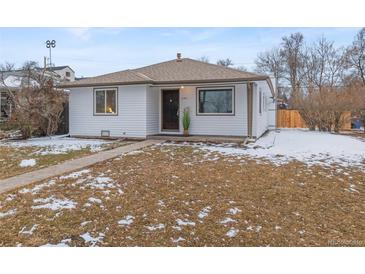 Charming home featuring a well-maintained lawn and a welcoming front porch at 1195 Ammons St, Lakewood, CO 80214