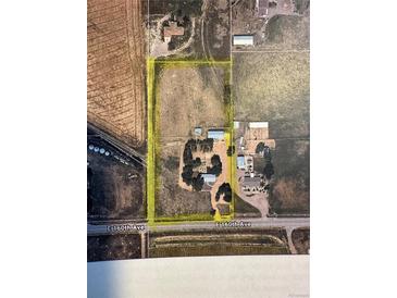 Aerial view of large property with trees, buildings and yellow boundary lines, with E 160th Ave in view at 1685 E 160Th Ave, Broomfield, CO 80023