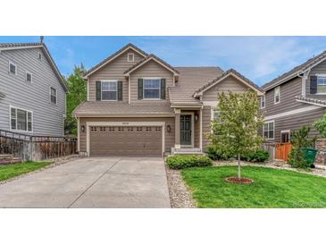 Charming home features a two-car garage, a well-maintained lawn, and neutral colored siding at 4214 Kestrel Pl, Castle Rock, CO 80109