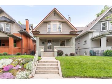 Charming two-story home with a front porch and beautifully landscaped yard at 506 N Marion St, Denver, CO 80218