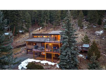 Stunning mountain home featuring multiple decks perfect for enjoying serene views and outdoor living at 6080 Kilimanjaro Dr, Evergreen, CO 80439