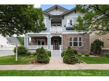 Charming two-story home with stone accents, covered porch, and well-maintained landscaping at 11702 Perry St, Westminster, CO 80031