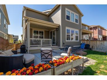 Charming backyard featuring a cozy patio, colorful flower beds, and green grass at 723 176Th Ave, Broomfield, CO 80023