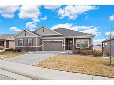 Ranch-style home with a two-car garage and landscaped yard at 12664 Ulster St, Thornton, CO 80602