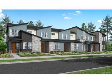 Modern townhome community with stone and siding exteriors at 5688 N Killarney Ct, Aurora, CO 80019