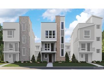 Modern townhomes with sleek design, featuring mixed materials, windows, and professional landscaping at 1218 Dylan Dr, Erie, CO 80026