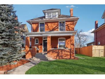 Brick two-story home with a landscaped lawn and porch at 1086 S Pearl St, Denver, CO 80209