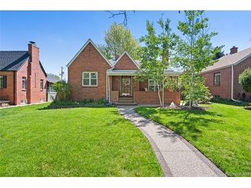 Charming brick home with a well-manicured lawn and a stone walkway leading to the entrance at 1434 Clermont St, Denver, CO 80220